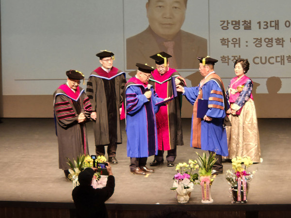 미국 캘리포니아에 있는 CUC(크리에이티브대학교) 토마스 심박사 총장이 강명철 이사장에게 경영학 명예박사 학위를 수여하고 있다. /사진=김영동 기자