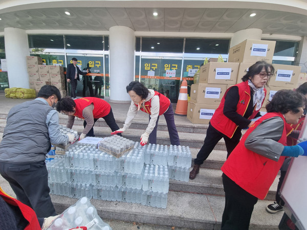 문경시종합자원봉사센터 백화자 센터장(가운데)과 관내 자원봉사 단체장들이 지원 물품을 정리하고 있다. /사진제공= 문경시종합자원봉사센터